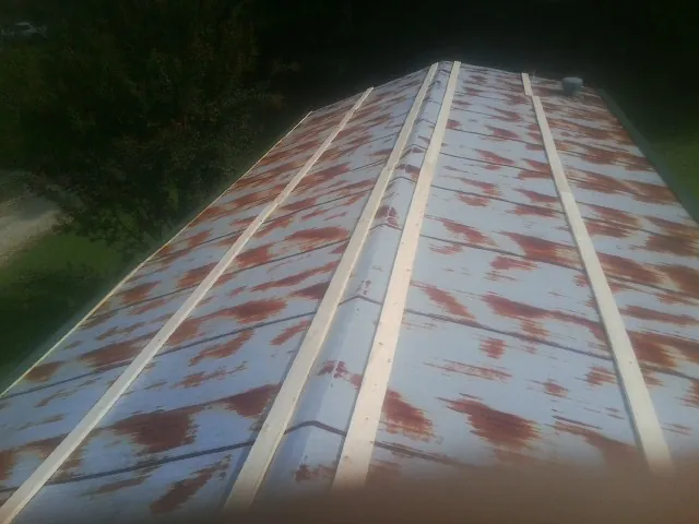 Rusted metal roof panels with new wood purlins before replacement — Storm Damage Roof Repair in Lakehurst by Roofing Brothers
