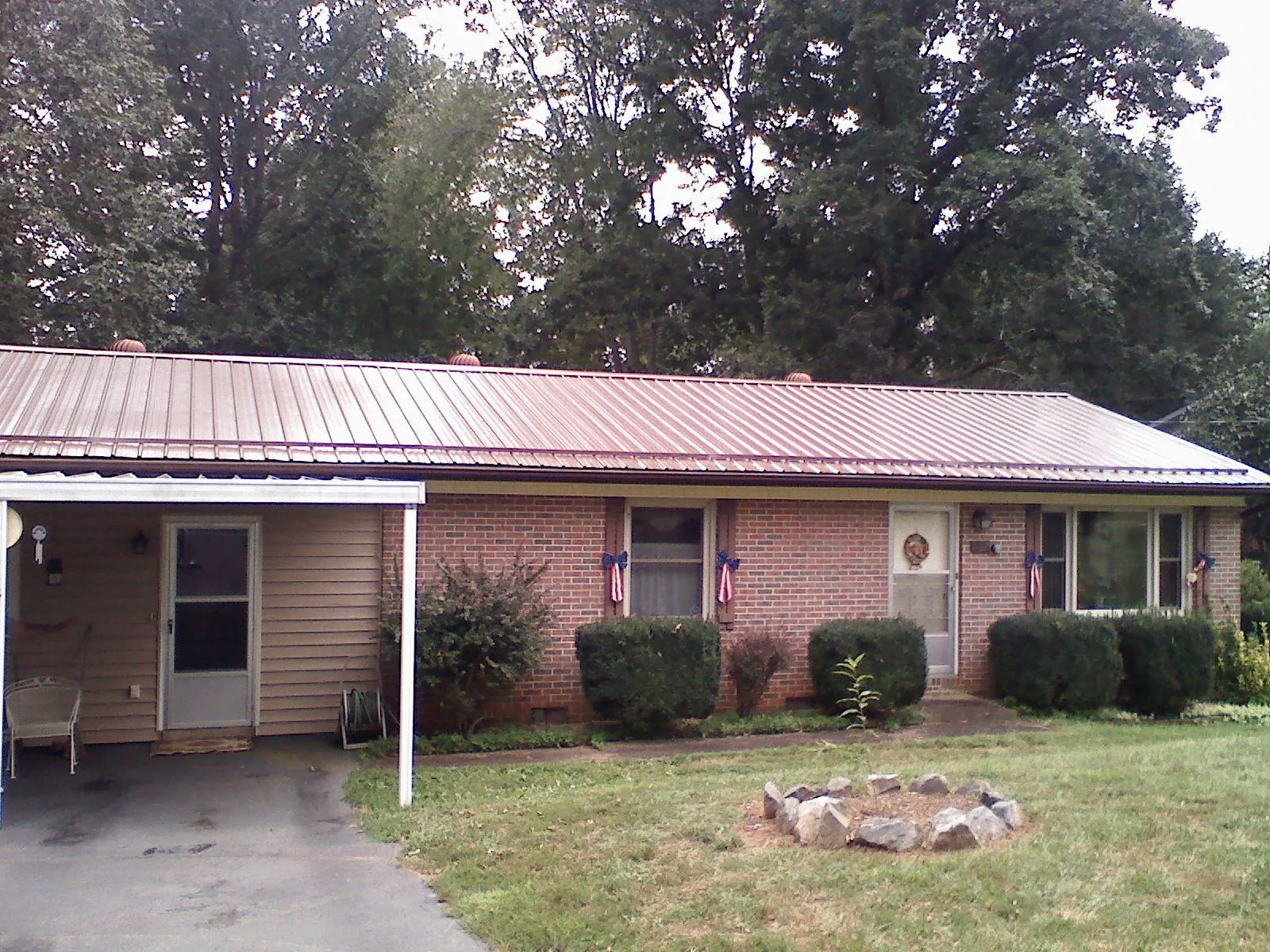 Bronze metal roof and carport on a brick ranch home — Roof Repair work by our crew in Lakehurst
